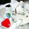 snowmen play cards at the garden